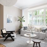 3D animation home interior showing a minimalist living room with neutral colors, modern seating, soft textiles, natural daylight, and a calm residential atmosphere