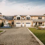 3D architectural rendering of modern residential complex with driveway courtyard and landscaped surroundings