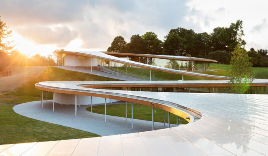 Minimalist curved Glass Facade Architecture with transparent glazing by SANAA Pavilion